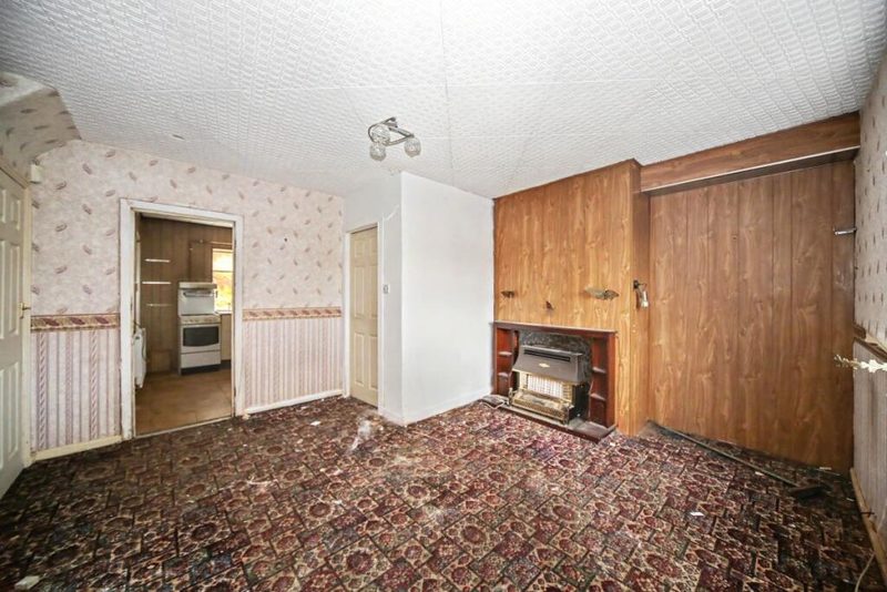 Lounge diner with dated decor and gas fire